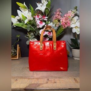 Authentic Louis Vuitton Reade PM handbag in Red Monogram Vernis patent leather.